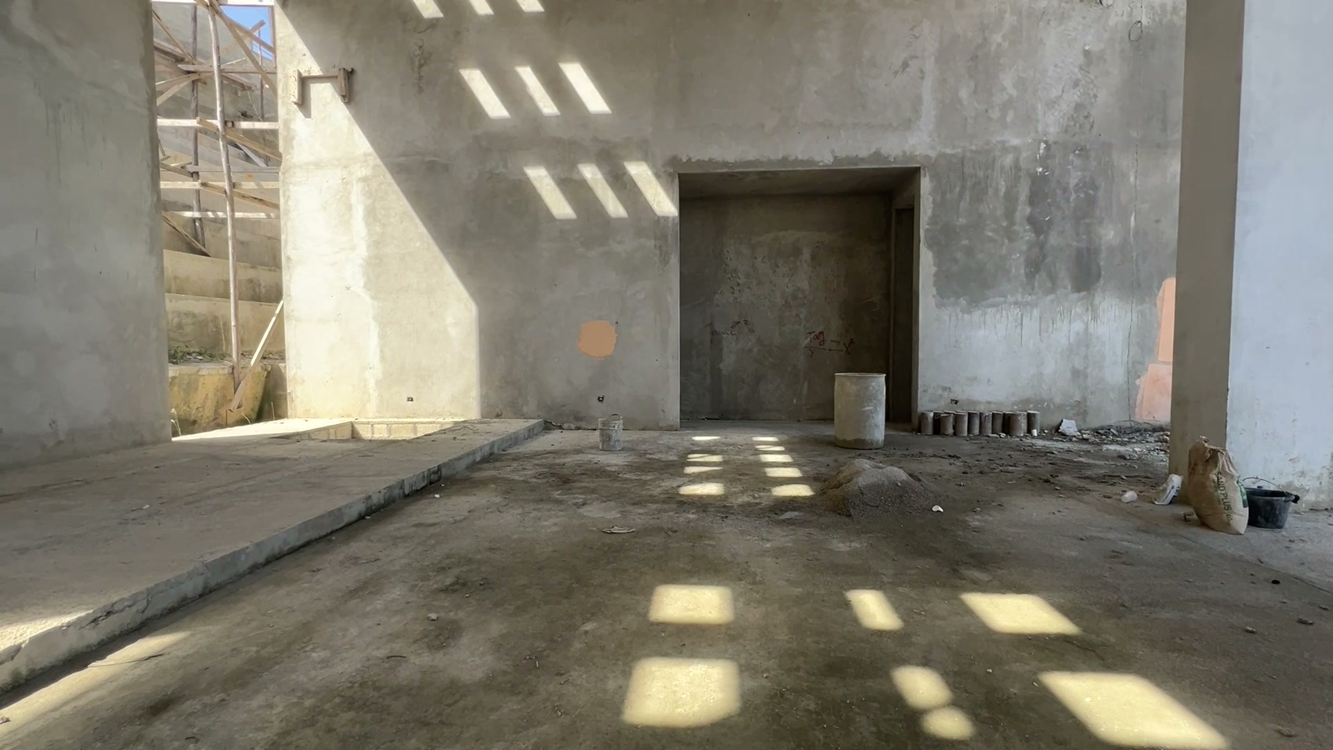 Squares of sunlight on the floor from openings in the roof