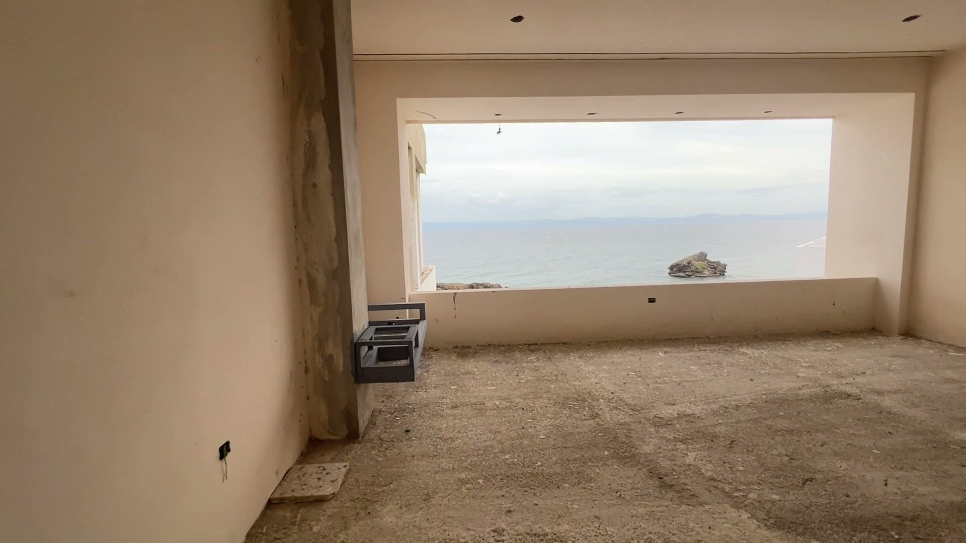 A plastered room opening onto the sea