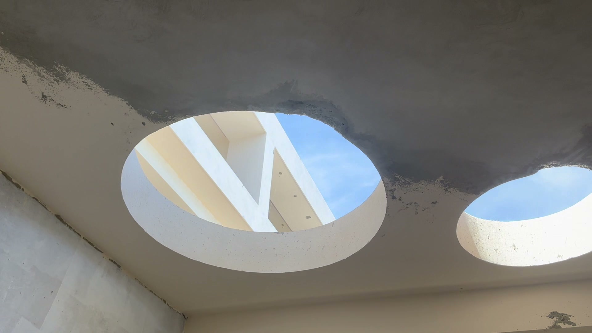 Round openings cut through a concrete ceiling